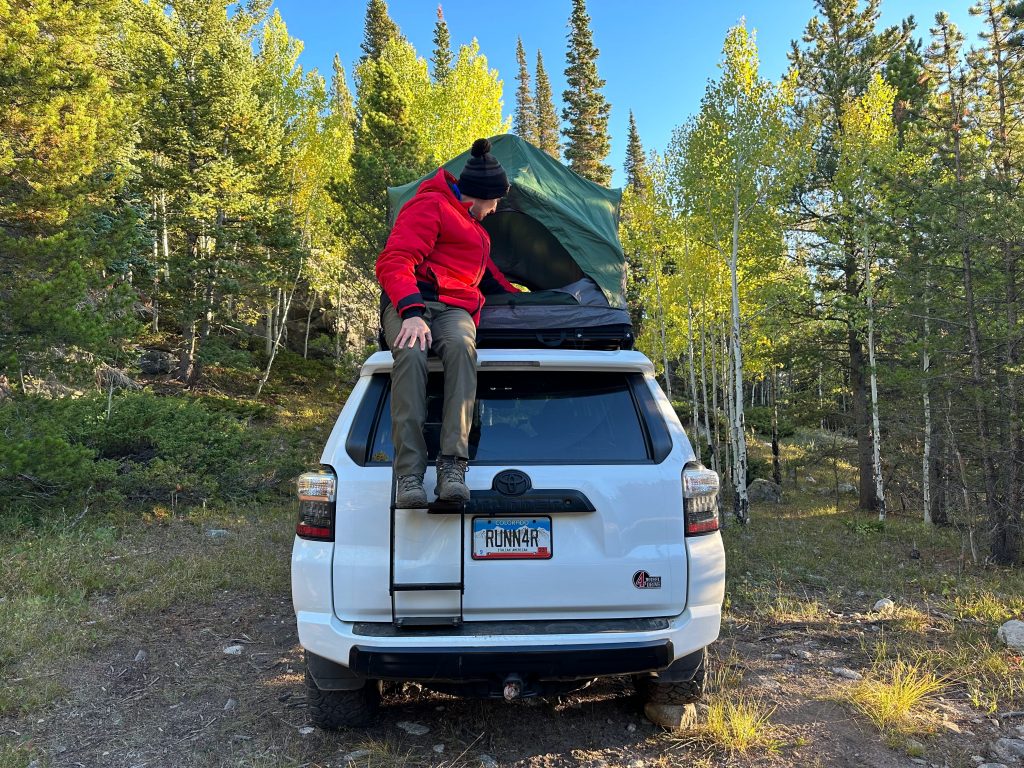 Using the ladder on the 4Runner to access the Rev Tent