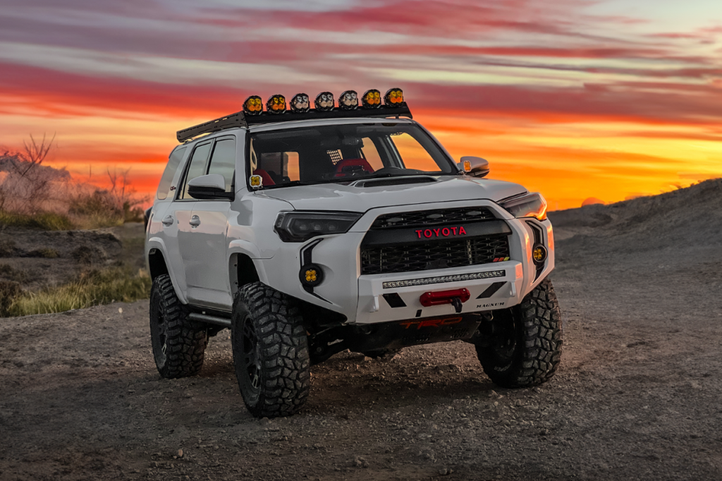 Lifted White 5th Gen 4Runner With White Color Matched Low Profile Front Bumper & Baja Designs Pod Light Bar On Roof Rack